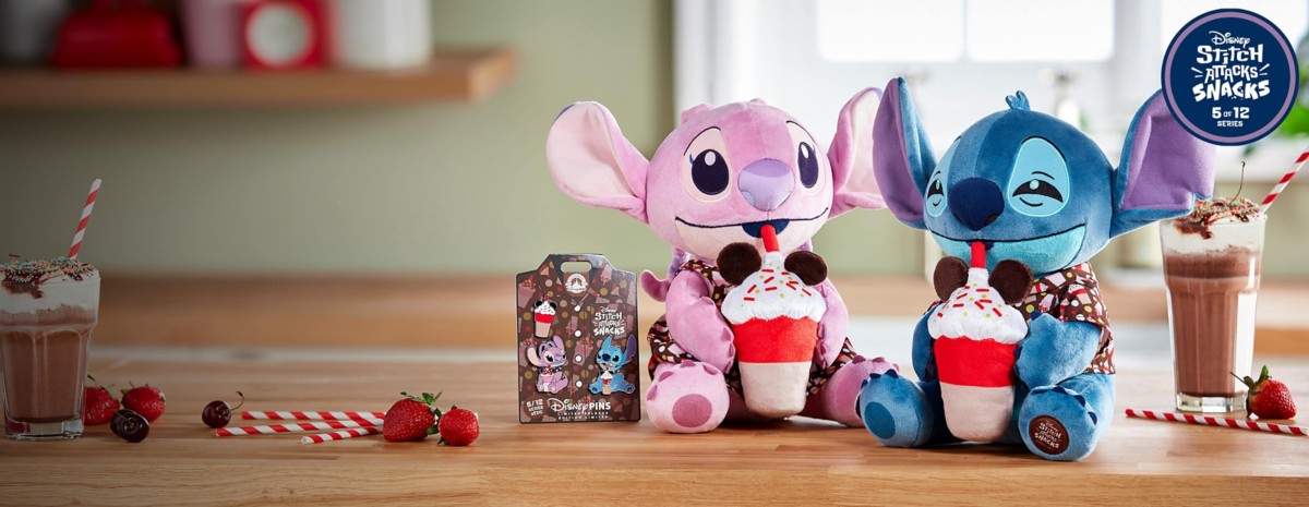 Angel and Stitch plush dolls sipping Mickey milkshakes. Disney Stitch, Angel, and ice cream pins displayed next to Angel plush and chocolate milkshakes on a table.
