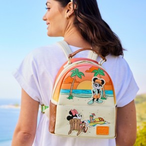 Woman wearing Disney Loungefly mini backpack with Mickey and Minnie at the beach in vibrant colors.