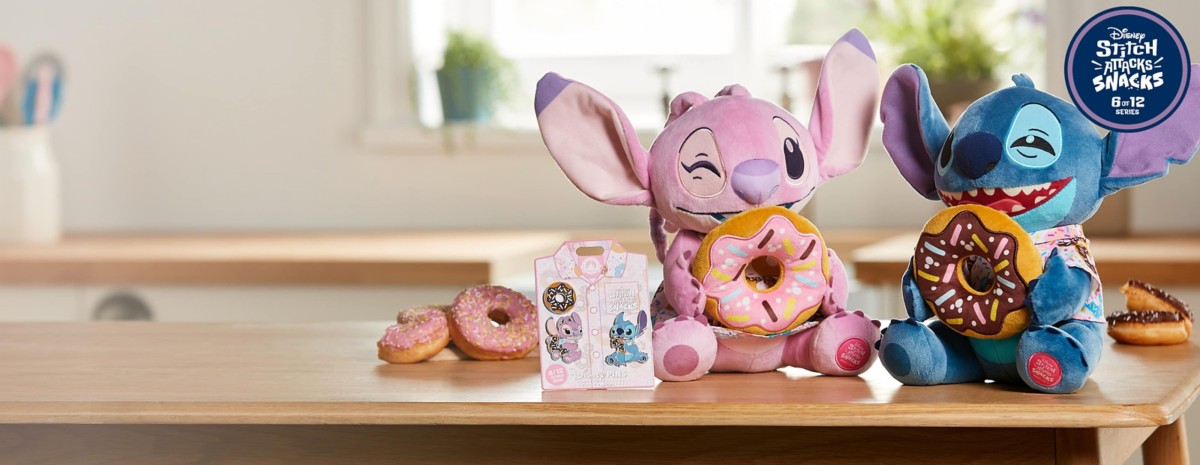 Angel and Stitch plush dolls sipping Mickey milkshakes. Disney Stitch, Angel, and donut pins displayed next to Angel plush and donuts on a table.