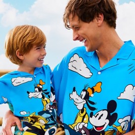 Dad and Son wearing matching Mickey & Co Vacay printed button down shirts.